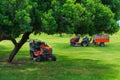 Lawn mower machines on green field. Summer garden ritual Royalty Free Stock Photo