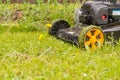 Lawn mower. Mow the lawn with a lawn mower. Royalty Free Stock Photo