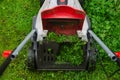 lawn mower mows grass on the lawn Royalty Free Stock Photo