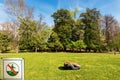 Lawn Mower Robot and Prohibition Sign of Not to Walk on the Grass