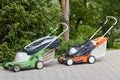 lawn mowers on the sidewalk made of paving stones Royalty Free Stock Photo
