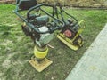 Lawn mowing machine. huge lawnmower on oil and gasoline. hand tool for creating a smooth landscape. metal construction with Royalty Free Stock Photo