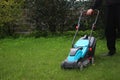 Lawn mowing. Man holding the handle of a lawn mower Royalty Free Stock Photo