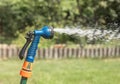 Lawn sprinkler in grass pouring watering grass with defocused drop and splash