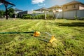 Lawn sprinkler spaying water over green grass. Irrigation system Royalty Free Stock Photo