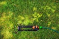 Lawn sprinkler spaying water over green grass. Royalty Free Stock Photo