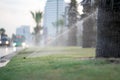 Lawn sprinkler spraying water over green grass. Watering lawns Royalty Free Stock Photo