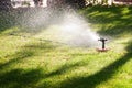 Lawn sprinkler watering the grass Royalty Free Stock Photo