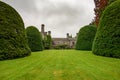 Lawn and tall pruned yews at Gwydir Castle