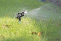Lawn Water Sprinkler Spraying Water Over Grass