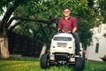 Lawncare concept - Smiling worker using ride on grass mower Royalty Free Stock Photo