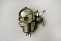 The lawnmower carburetor is a device for supplying a spark-ignition engine with a mixture of fuel and air. Royalty Free Stock Photo