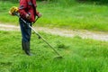 Lawnmower. Worker, a man holding a lawn mower. Landscape gardening work.