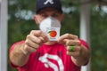 A Georgia voter wearing a mask holds up his I Voted sticker after voting in the 2020 U.S. Royalty Free Stock Photo