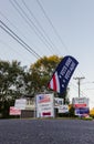 LAWRENCEVILLE, UNITED STATES - Nov 03, 2020: Campaign signs along the side of the road near a polling location in Gwinnett County