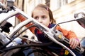 Laws for child drivers under 18 concept. Llittle biker child girl sitting on a motorcycle