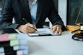 Lawyer business man working with paperwork on his desk in office workplace for consultant lawyer in office Royalty Free Stock Photo