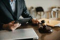 Lawyer business man working with tablet and paperwork on his desk in office workplace for consultant lawyer in office Royalty Free Stock Photo