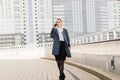 Lawyer businesswoman professional walking outdoors talking on cell smart phone drinking coffee from paper cup Royalty Free Stock Photo