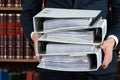 Lawyer Carrying Stack Of Ring Binders