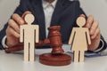 Lawyer or counselor holds figures of family, divorce or separation concept. Close-up Royalty Free Stock Photo