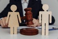 Lawyer or counselor holds gavel behind of figures of young family, divorce and law concept Royalty Free Stock Photo