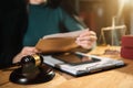 Lawyer with gavel and scales working on a monograph at home office. Royalty Free Stock Photo