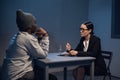 A lawyer girl with glasses and a young black guy communicate in the interrogation room about the grounds for his