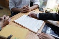 Lawyer hands important documents to couple to sign