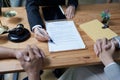 Lawyer hands important documents to couple to sign