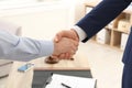 Lawyer handshaking with client over table in office Royalty Free Stock Photo