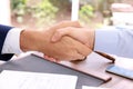 Lawyer handshaking with client over table in office Royalty Free Stock Photo