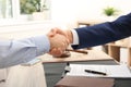 Lawyer handshaking with client over table in office Royalty Free Stock Photo