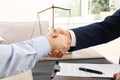 Lawyer handshaking with client over table in office Royalty Free Stock Photo