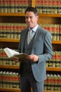 Lawyer holding book in the law library