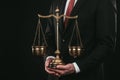 Lawyer holding themis scales isolated on black Royalty Free Stock Photo