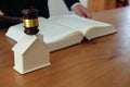 lawyer with judge gavel knocking house model with law book. real Royalty Free Stock Photo