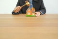 lawyer with judge gavel knocking house model. real estate dispute & property auction concept Royalty Free Stock Photo