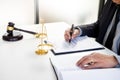 Lawyer judge reading writes the document in court at his desk