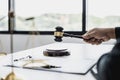 A lawyer or legal advisor holding a small hammer for a judge`s table in court is about to pound on the podium Royalty Free Stock Photo