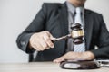 A lawyer or legal advisor holding a small hammer for a judge`s table in court is about to pound on the podium Royalty Free Stock Photo