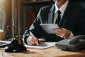 Lawyer office. gavel of Justice with scales and lawyer working on a laptop. Royalty Free Stock Photo