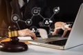 Lawyer office. gavel of Justice with scales and lawyer working on a laptop. Royalty Free Stock Photo