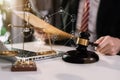 Lawyer office. gavel of Justice with scales and lawyer working on a laptop. Royalty Free Stock Photo