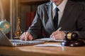 Lawyer office. gavel of Justice with scales and lawyer working on a laptop. Royalty Free Stock Photo