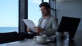 Lawyer reading contract papers at sea view. Manager professional at work Royalty Free Stock Photo