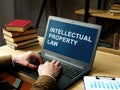 Lawyer reads about Intellectual property law on the laptop. Royalty Free Stock Photo