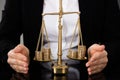 Lawyer`s Hand Protecting Justice Scale With Coins Royalty Free Stock Photo