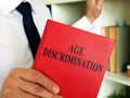 A lawyer shows an Age discrimination law book. Royalty Free Stock Photo