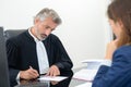 Lawyer signing document in office with female client Royalty Free Stock Photo